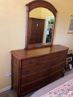 Full view of Bassett double dresser with mirror showing nine drawers and polished wood surface.