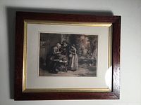 Full view of framed antique etching featuring village scene with seafood preparation.