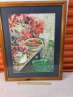 Full view of the framed print showing the floral still life with green chair and fruit bowl.