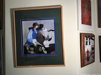 Full view of the framed serigraph print by Itzchak Tarkay featuring a seated woman in colorful attire, with green and blue double matting and light wood frame.