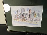 Framed original watercolor painting by Roger Connery showing a stylized cityscape and beach titled Brighton Beach.