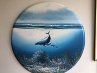 Front view of the full oval oil painting showing mother humpback whale and calf underwater with ocean surface above.
