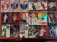 Photo showing a collection of 20 basketball cards featuring various rookie, complete player, select series, and autographed cards.