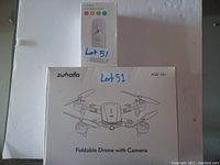 White box of Zuhafa foldable drone with camera and a box containing a 2-pack LED night light.