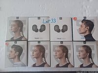 Photo showing 8 boxed pairs of Sennheiser wireless earbuds from various model lines, stacked in two rows on a white background.
