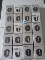 Photo showing front faces of 20 boxed L8Star smart watches arranged in 4 rows of 5 boxes each.