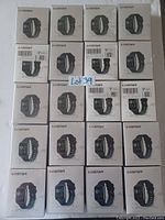 Single image showing 20 sealed retail boxes of LeStar smart watches arranged in a grid.