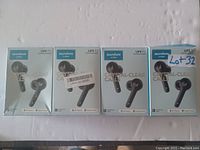 Photo showing four sealed retail boxes of Soundcore Life P2 earbuds, arranged horizontally. Boxes confirm brand, model and packaging design.