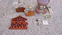 Five carousel horse-related items shown on carpet including lamp, wooden silhouettes, musical horse figure, and carousel telephone.