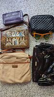 Photo showing five handbags and one pair of Margarita sunglasses: purple wallet, black quilted bag, brown tooled leather clutch bag, beige bag, dark brown shiny bag