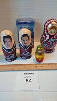 All four nesting dolls shown together, including two Colorado Avalanche player dolls sponsored by Conoco and two Russian themed nesting dolls.