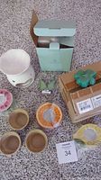 Overview of lot showing wax melt and various tea light holders including some floral and fruit shapes, some still boxed or wrapped