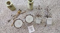 Photo showing all items in the lot including six candle holders, two snuffers, and one wick trimmer arranged on carpet.
