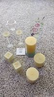 Overview photo showing all candles and the hand painted vase on carpeted floor