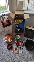 Wide shot of the lot items arranged on carpet including witches, cauldrons, candles, candy, and spell book.