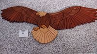 Full front view of the wooden eagle wall art piece showing its wide wingspan and detailed wood grains.
