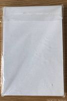 Pack of 50 white coated photo cards sealed in clear plastic packaging showing front view of cards.