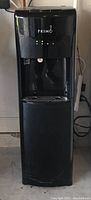 Full front view of the Primo water cooler showing its height and front panel with controls and branding.