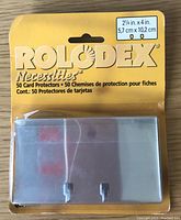 Photo of sealed original packaging of 50 clear plastic Rolodex card protectors, packaging indicates dimensions 2 1/4 x 4 in and brand Rolodex Necessities.