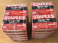 Two unopened stacks of Staples #1 paper clips, each stack contains 10 boxes of 100 clips, total 20 boxes.