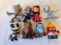 All eight figures from the lot arranged together showing size and design.