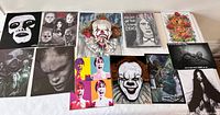 Full lot of 12 signed horror fan art prints, mostly 8x10, displayed flat on a white surface.