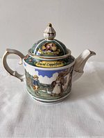 Front view of the David Copperfield teapot showing illustration of children and rural scenery with Charles Dickens portrait on lid.