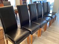 Six chairs lined up in a row showing overall set