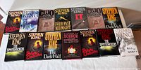 Top view showing all 14 Stephen King hardcover books arranged in two rows, including titles Dolores Claiborne, Dreamcatcher, Cujo, Four Past Midnight, IT, The Dark Half, The Tommyknockers, and Masters of Horror.