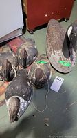 Overview of all four wooden waterfowl decoys on floor