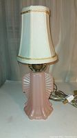 Front view of the antique pink frosted glass lamp with white shade showing overall shape and detailing.