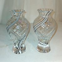 Pair of Caithness Edinboro Scotland art glass vases with spiral swirl design, 6 inches tall each, placed side by side on a light background