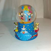 Front angle showing Mickey and Minnie Mouse inside the globe with Cinderella and others on the base.