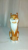Front view of the porcelain lynx figurine showing detailed face and coloration.