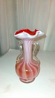 Front view of Murano glass vase showing the orange swirl pattern and clear glass handles on sides