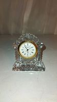 Front view of small crystal clock showing clock face and Waterford signature design