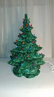 Front view of ceramic Christmas tree with colorful light-up pegs.
