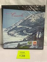 Front cover of sealed 1997 Collection Canada book featuring scenic winter road and stamps