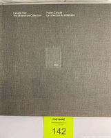 Closed front view of grey fabric hardcover album with 'Canada Post The Millennium Collection' and embossed '2000' square on the cover.