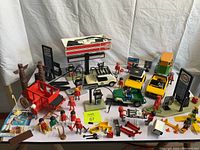 Front view of lot showing Esso gas station, vehicles, stagecoach and multiple figures and accessories.