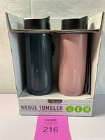 Two vacuum insulated tumblers in packaging, one dark green and one light pink, each with a black lid, labeled as Wedge Tumblers by reduce brand.