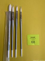 Four new Silverwhite 1500 Round paint brushes laid on yellow background with label 68.