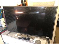 Front view of 42" LG LED TV on countertop, screen off, showing light dust and smudges