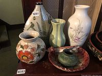 Wide shot showing all vases and bowl on a table with visible tags 0281 and 0283, showcasing the set overall.
