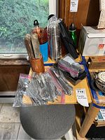 Photo showing wooden knife block with knives along with six ziplock bags containing various silver-tone flatware pieces.