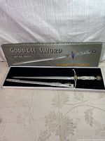 Full view of the collectible goddess sword in its presentation box with lid showing product name.
