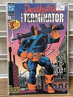 Front cover of the comic book featuring Deathstroke character and title, showing the signature and issue details.