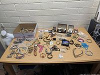 Wide top-down view of entire jewelry collection on table