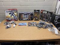 Wide shot of all boxed and loose items on table showing the total lot contents