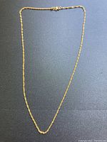 Full view of 18-inch rope chain laid flat on black surface